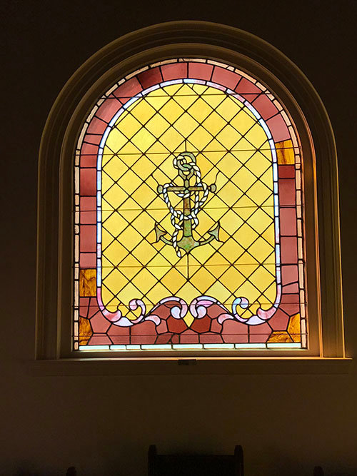 An anchor serves as the focal point in the main stained glass chapel window at the Seafarers House in the historic district. JOE WESTBURY/Index 