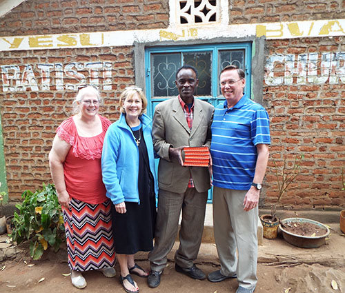 Left to right, Elaine Stockton, Jane Wells, and David Stockton stand with a Baptist pastor in Banatti, Tanzania. Wells serves Damascus as chair for the church's Missions Committee. DAVID STOCKTON/Special
