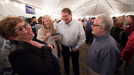 Lily Llambes, left, and her husband, Carlos, right, share a moment of levity with Courtney Lewis and her father, Greg Brown, during a celebration of 50 new Southern Baptist missionaries Nov. 10. The missionaries are sent through the International Mission Board in partnership with their home churches. ROY BURROUGHS/IMB