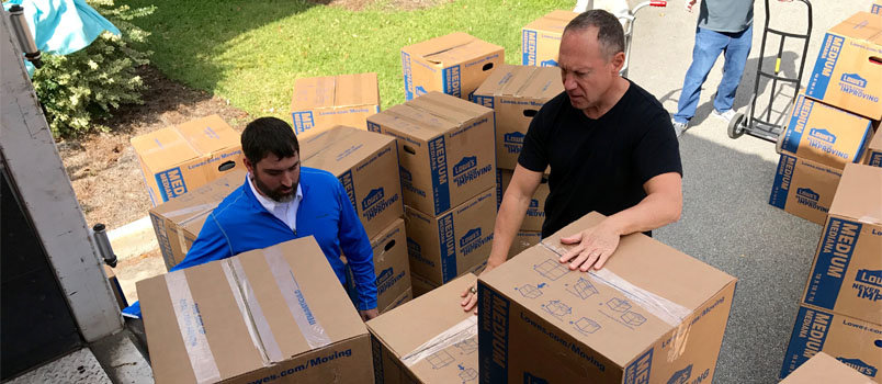 Campus Ministers Keith Wade, left, and Warren Skinner, right, help load boxes of packsacks into the 18-wheeler provided by the North American Mission Board. Wade serves at the University of North Georgia in Dahlonega and Skinner at Georgia Tech in downtown Atlanta. JOE WESTBURY/Index