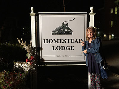 Janet Jones, wife of BCM's Ken Jones, stands by sign acknowledging that their ministry center has been transformed into a lodge, if for just for a few weeks. KEN JONES/UNG BCM