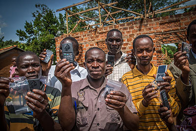 Pastors hold up their Messengers after a distribution in small village outside of Jinja, Uganda. INTOUCH/Special