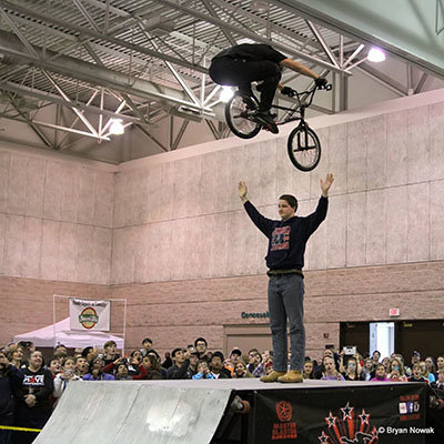 A member of the crowd displays another kind of faith with a member of the BMX Trickstars team. BRYAN NOWAK/Special