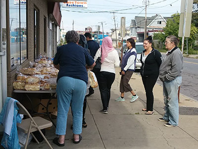 Members of The Neighborhood church pass out bread on the street. NEIGHBORHOOD CHURCH/Special