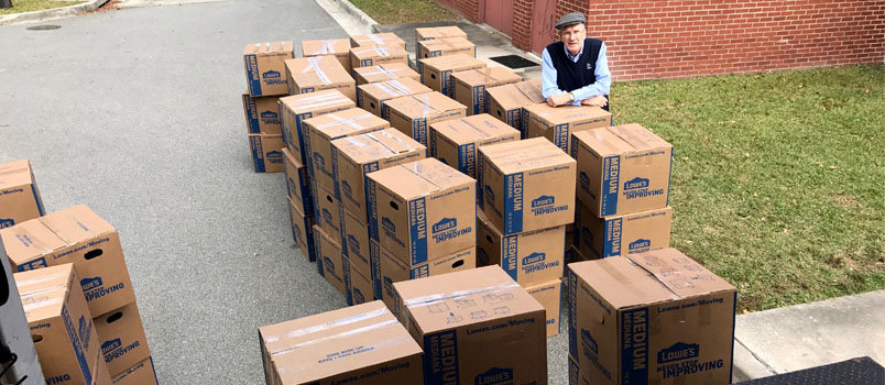 NAMB Missionary Bill Barker, who oversees the Appalachian Regional Ministries and the annual backpacks collection, poses with some of the nearly 40,000 backpacks which Georgia Baptists brought to the annual meeting in Savannah last month. JOE WESTBURY/Index