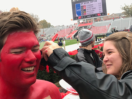 Carson Carter applies paint.