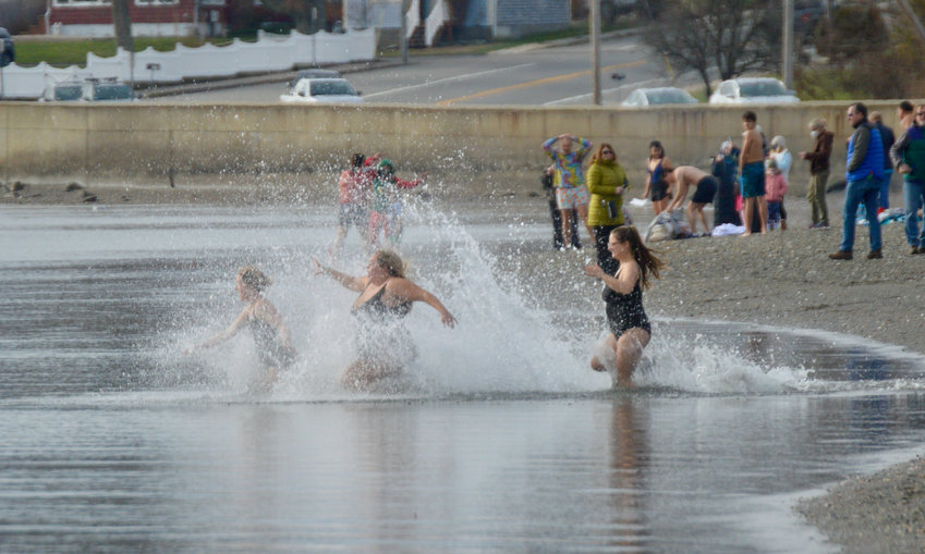 Emma Harvey, Brooke Saunders and Christina Halliday (from left) splash in the waters at Island Park Beach as they take a New Year&rsquo;s Day dip on Jan. 1, 2021. Although there was no &ldquo;official&rdquo; New Year&rsquo;s Day dive that day, several people jumped in anyway.