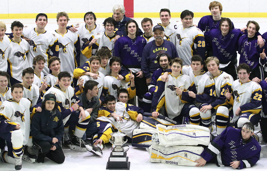 At the center of this 2020 post-game gathering of Barrington and Mt. Hope boys&rsquo; ice hockey players is J.P. Medeiros, father of the young man whose name has been memorialized with an annual hockey tournament and scholarship fund for two decades.