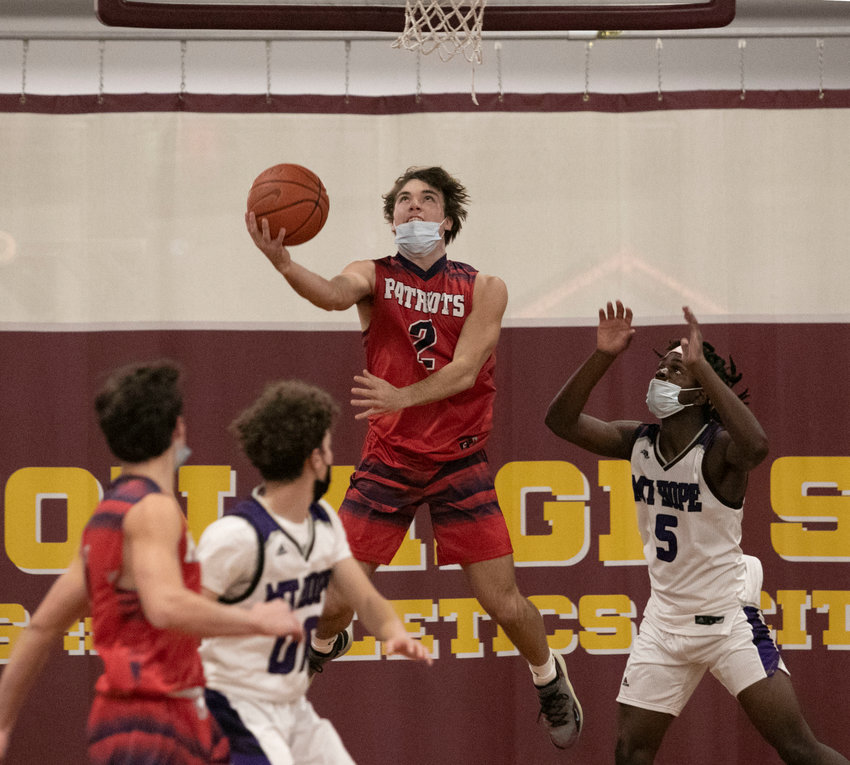 Ben Hurd attempts a reverse layup from under the basket during the Patriots&rsquo; game against Mt. Hope at Tiverton High School Tuesday. Portsmouth cruised, 60-41.