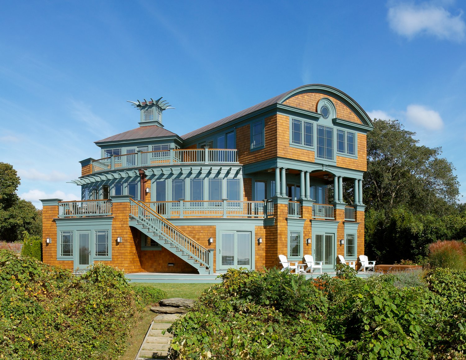 This modern shingle style residence is located in Westerly, overlooking  Quonochontaug Pond, with views of Block Island, Fisher’s Island and the Atlantic Ocean. The exterior draws its influence from historical New England structures, yet the traditional elements are purposely contrasted with a much more contemporary approach to the house’s form.