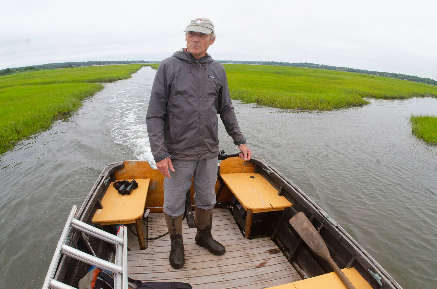 Dr. Alan Poole navigates the skiff through the marsh in the East Branch of the Westport River as they captured osprey fledglings for the Illinois osprey recovery program. 