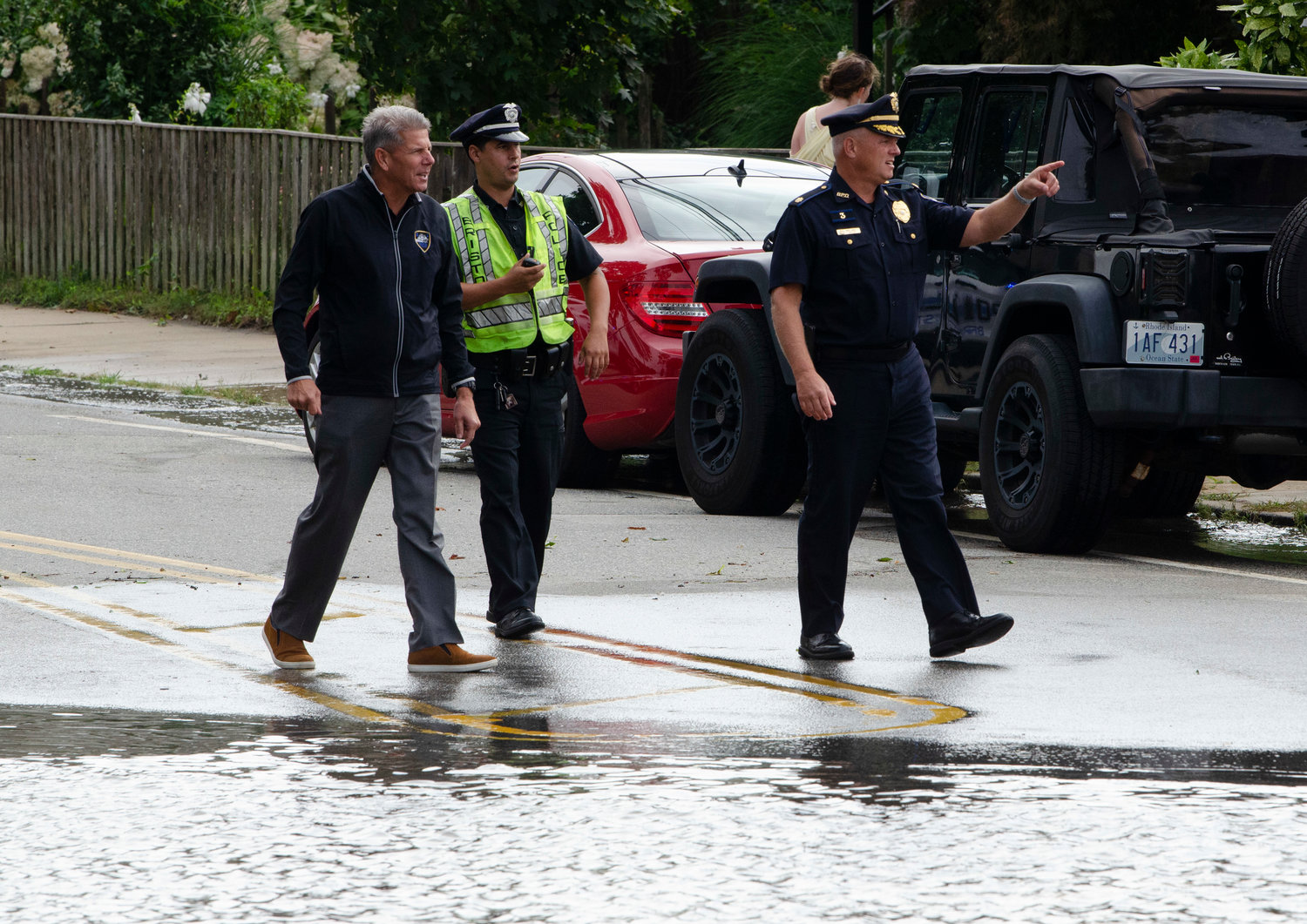 Bristol Police Chief Kevin Lynch (left), a patrolman and Major Scott McNally (right) check out flooded Washington and Hope Streets on Thursday morning.