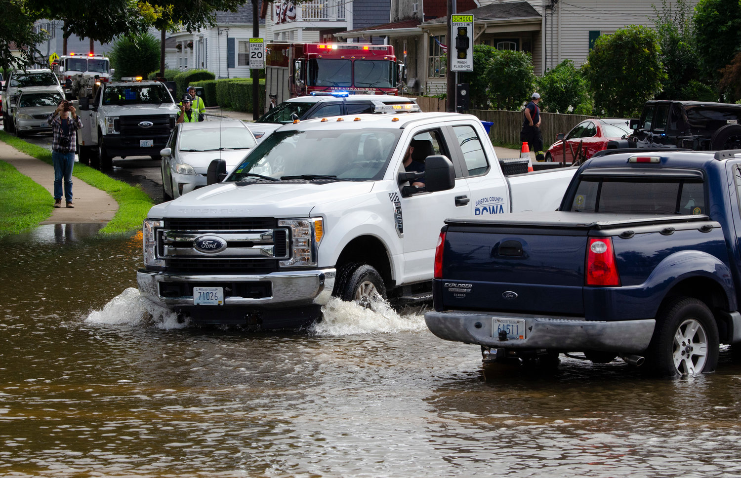 A BCWA employee powers a pick up truck through flooded Washington and Hope Streets on Thursday morning.