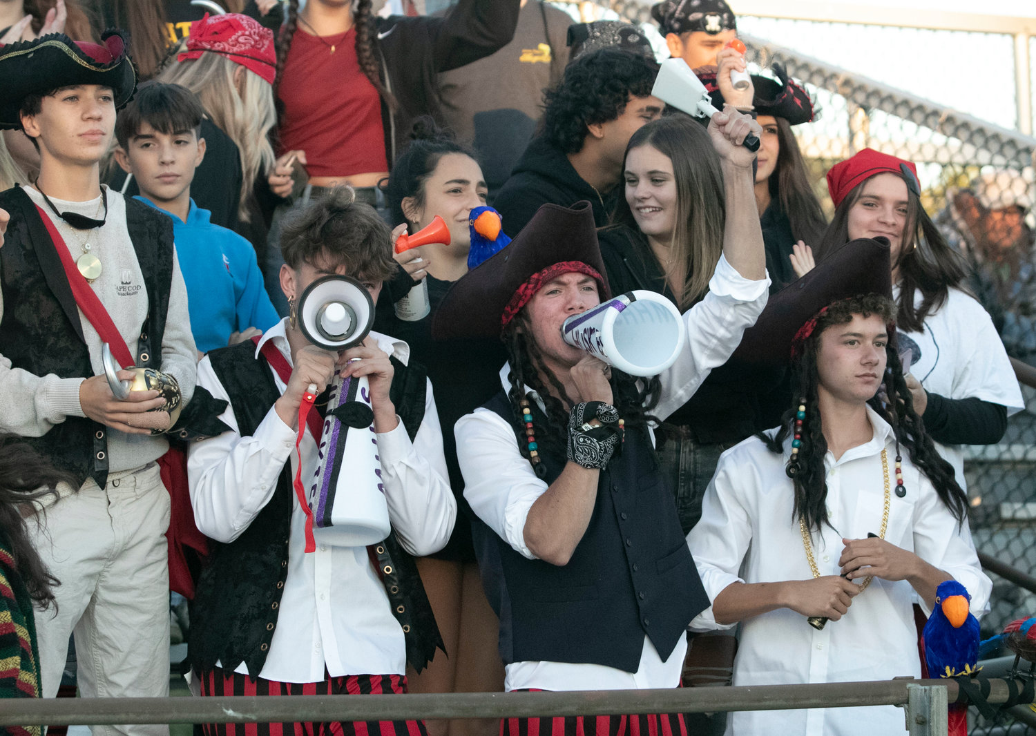 Ben Flynn (bottom left), Chris Frawley, Josh DeWolf and the Huskies ‘Dog Pound,’ cheered on the soccer team donned in pirate gear, prior to the football game that started at 7 p.m.