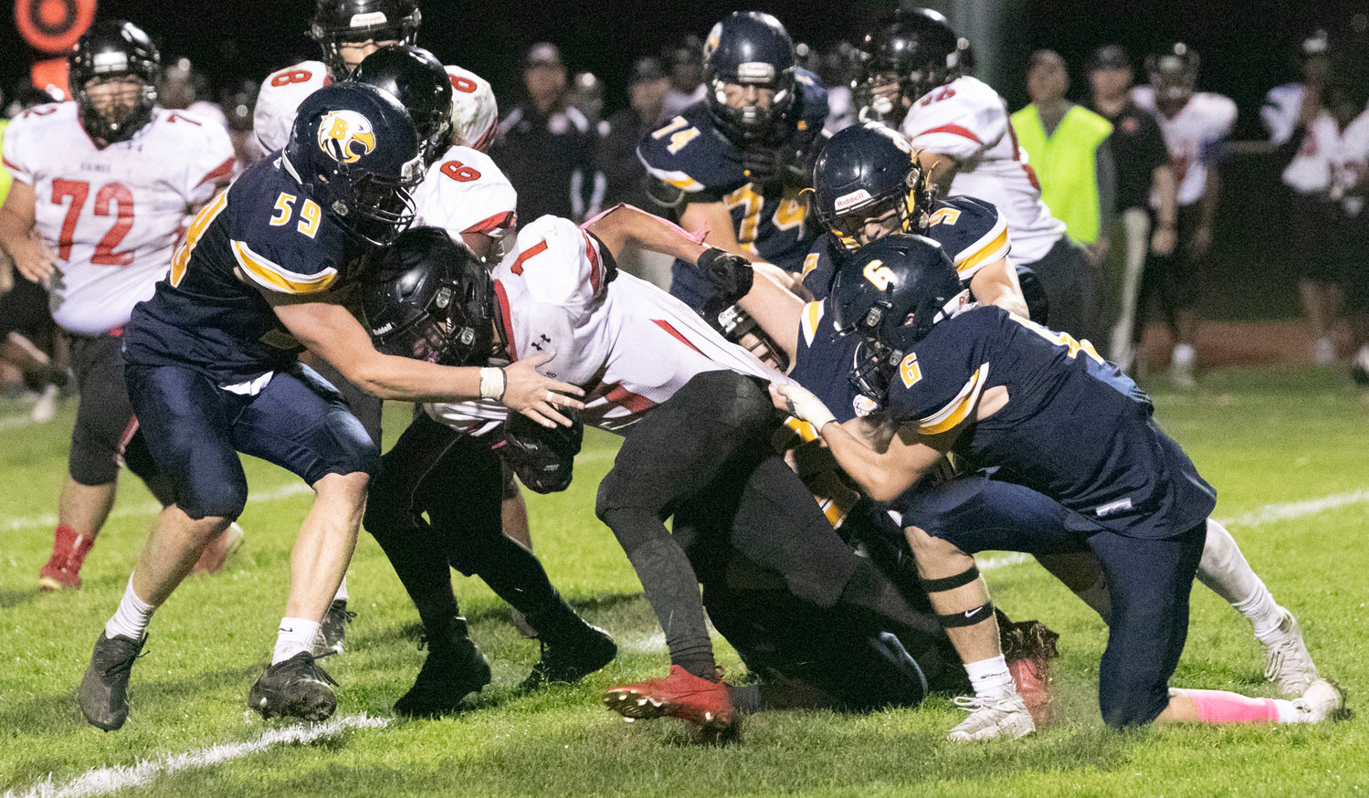 Barrington's Braeden Flaherty (6) and Will DiGiacomo (59) bring down a Rogers running back on Friday night.