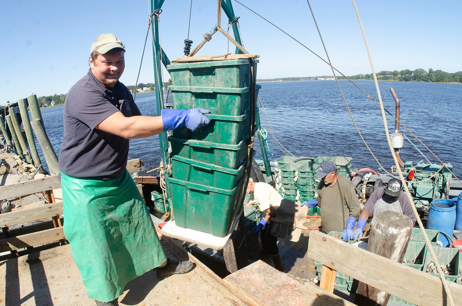 Chris Leonard, Westport's Director of Marine Services, loads containers of quahogs onto a trailer in Fall River early Friday afternoon. They were brought in by the dredger Ocean Rancher and unloaded at Ark Bait.