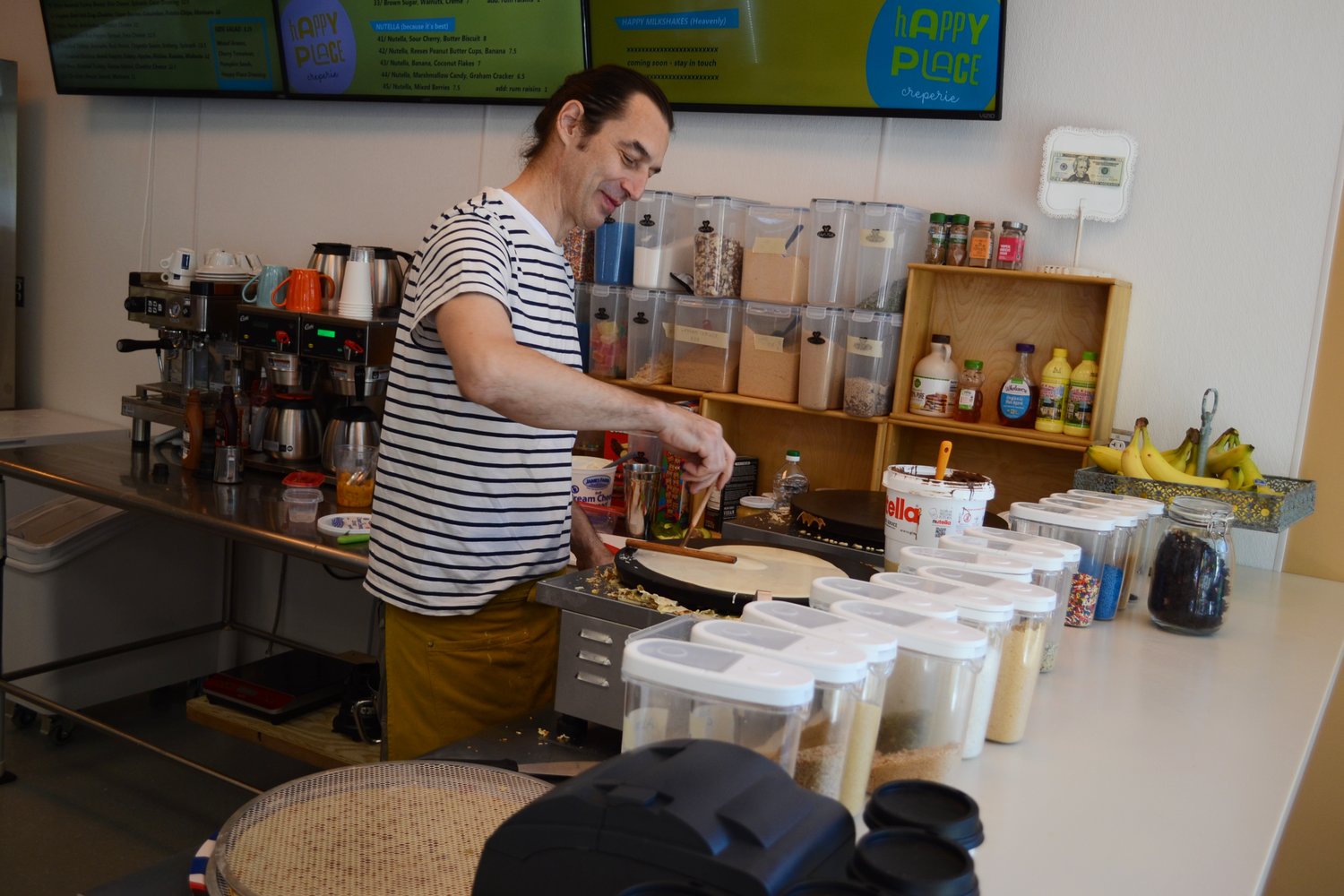 Aleksandar Janjic spreads batter onto one of the crepe griddles at Happy Place Creperie, located at 438 Main St. in Warren. The shop opened in August and serves up a wide variety of sweet and savory crepes.
