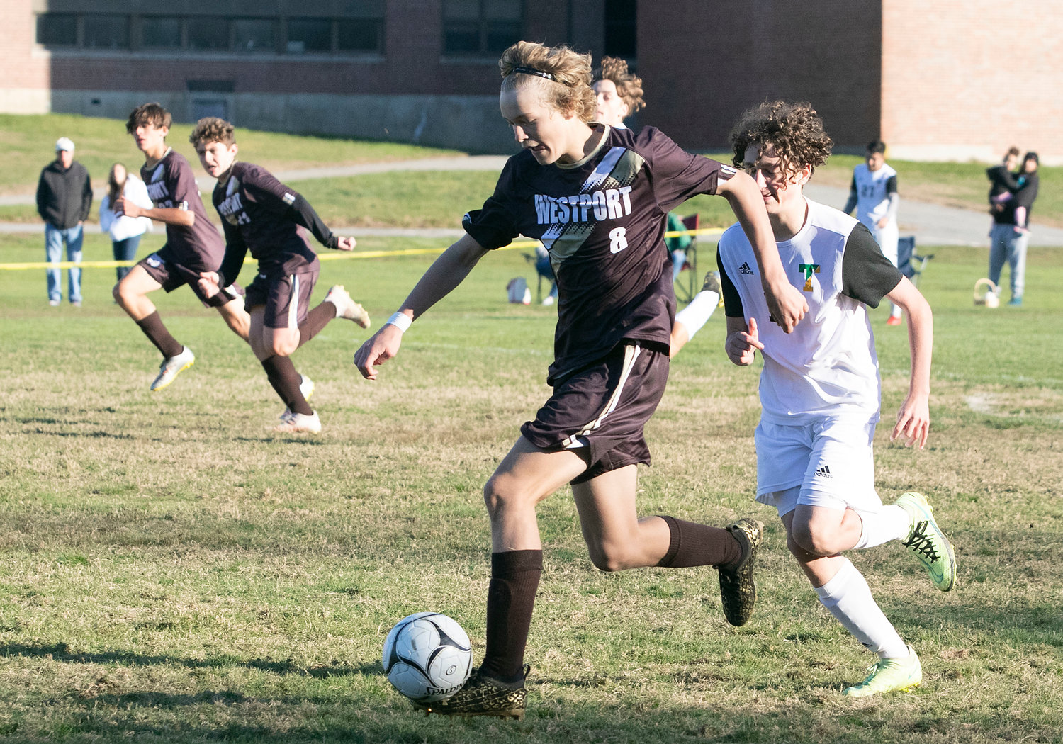 Coltrane McGonigle dribbles up the sideline with the ball. The junior scored the Wildcats first goal by heading a cross from Antonio Dutra Africano, into the goal for a Westport, 1-0 lead.