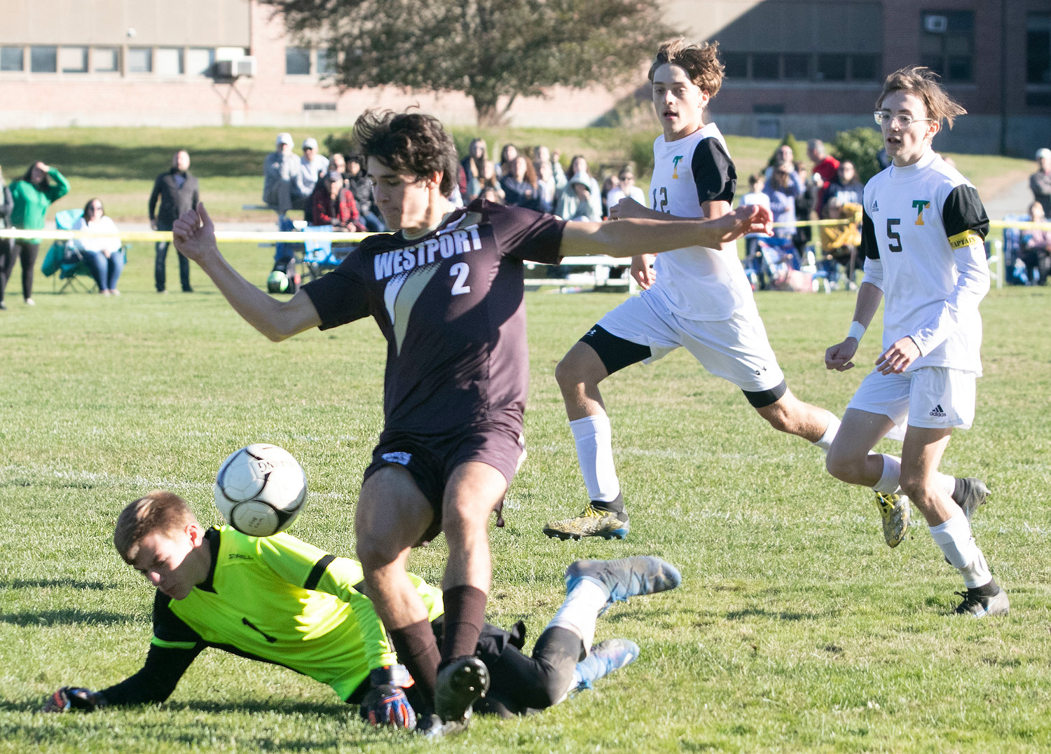 Striker Hunter Brodeur dribbles over Braves goalkeeper Tim Parsons and taps the ball into the net for his second goal of the game to give Westport a, 3-0 lead in the second half.