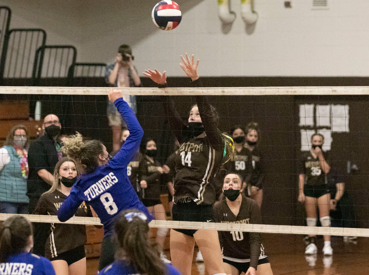 Madison Benson attempts a block with Abby Gaudreau (right).