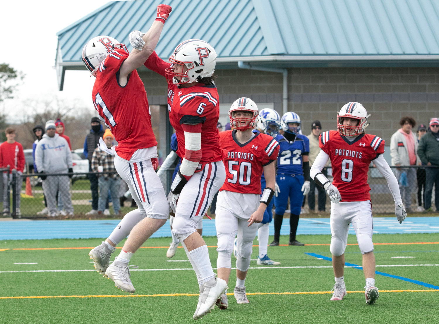 Gavin Bicho (left) celebrates with Marcus Evans after the latter scored a touchdown in the second half. Henry Rodrigues (left) and Jack Cianciolo are ready to join them.