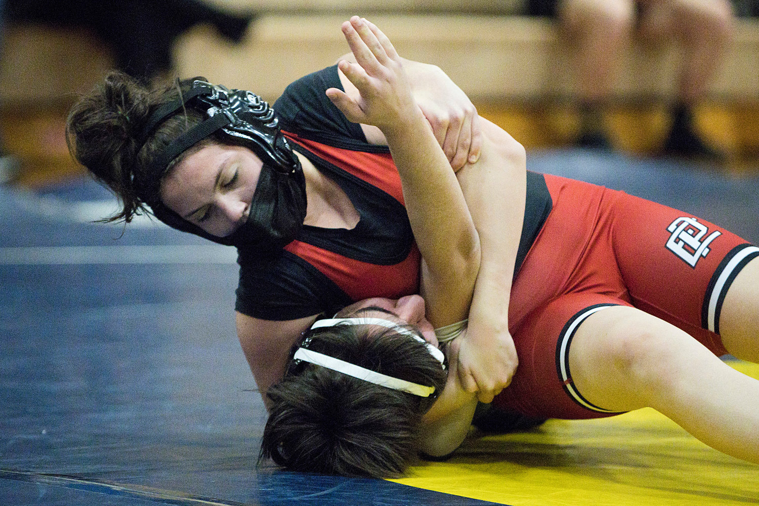 Ciara Nunes works to pin a Hendricken opponent while competing in the 132 weight class.