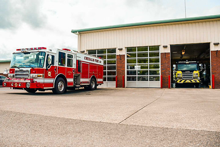 A Chehalis Fire Department truck is parked outside, while a Lewis County Fire District 6 truck is parked inside the Fire District 6 station on Jackson Highway in May.