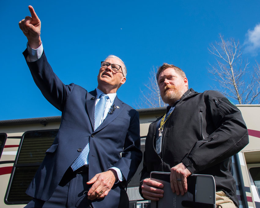 FILE PHOTO &mdash; Governor Jay Inslee points to the isolation area of a potential COVID-19 quarantine site during a tour with Washington State Department of Health Commander Nathan Weed at Maple Lane in early March.&nbsp;