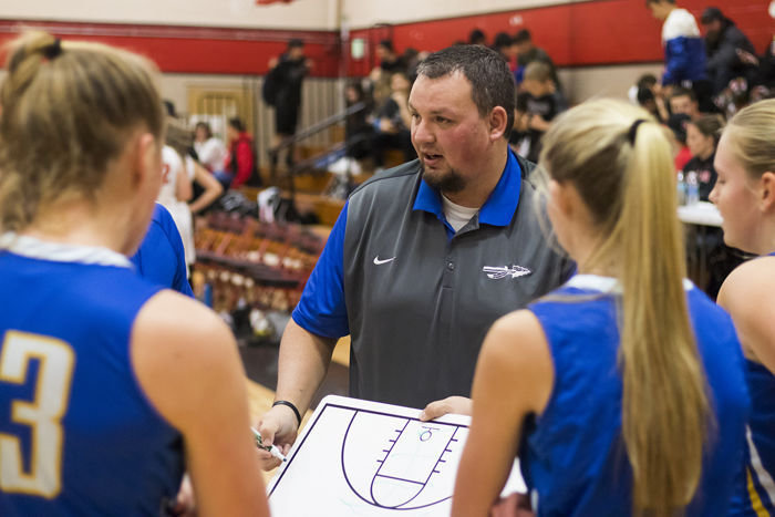 Rochester's Head Coach AJ Easley goes over plays with his team during a timeout Tuesday night at Tenino High School.