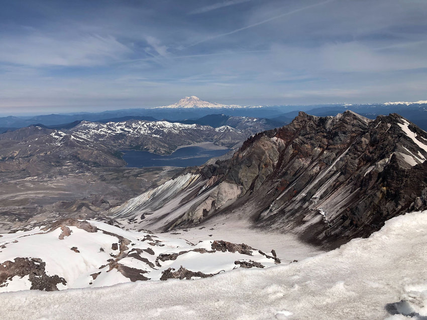 Mount Rainier and Spirit Lake are seen from the summit of Mount St. Helens.