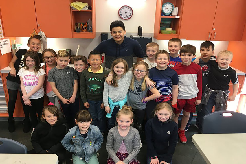 Boys and Girls Club of Chehalis Youth of the Year Rome Zucati poses with some of the children at the club