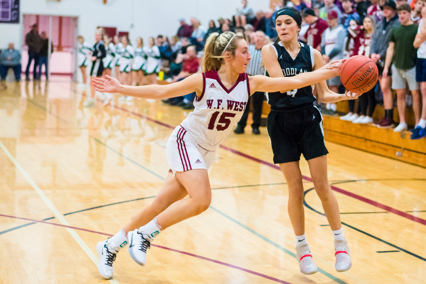 Bearcat's Madi Mencke (15) gets a steal during a game against Woodland Friday night at W.F. West High School.
