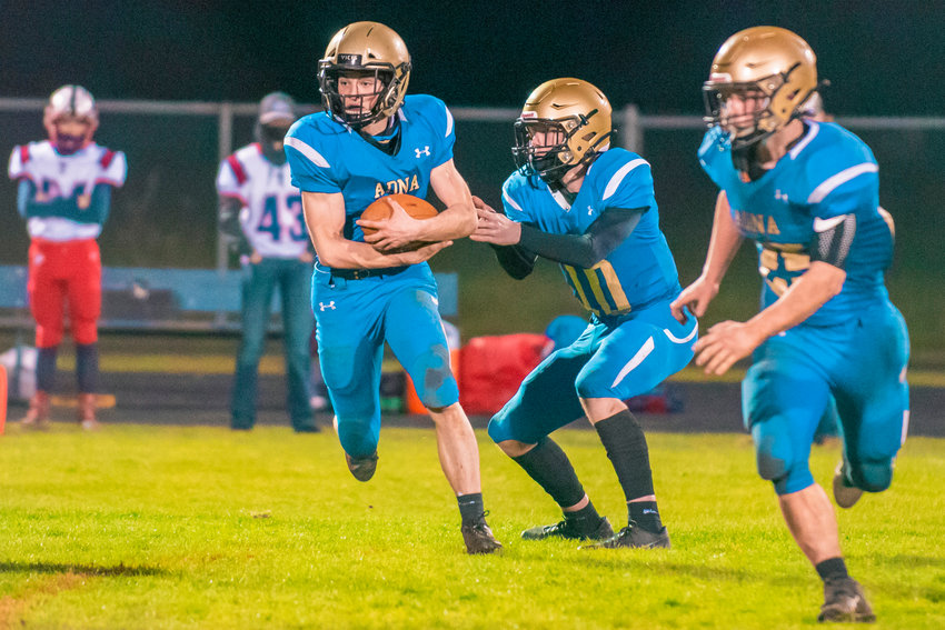 Adna&rsquo;s Lane Johnson (10) hands the ball off to Tristan Ridley (9) during a game against PWV in Adna on Wednesday.