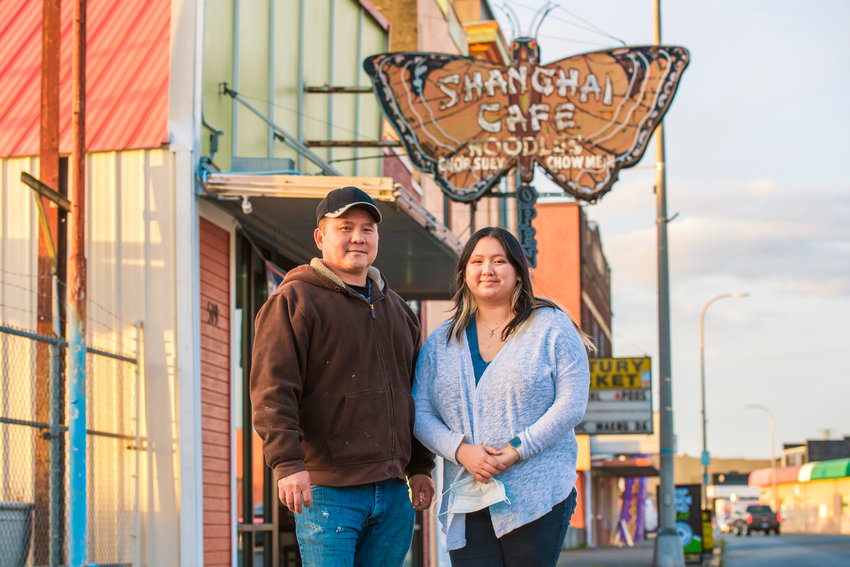 Hung Doan and his daughter Cindy smile and pose for a photo in front of the Shanghai Cafe in downtown Centralia on Tuesday.