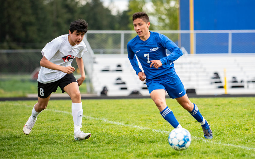 Rochester's Alexis Castillo-Corona (7) dribbles downfield against Centralia's Fernando Lopez (8) during the opening round of the 2A EvCo playoffs Saturday.