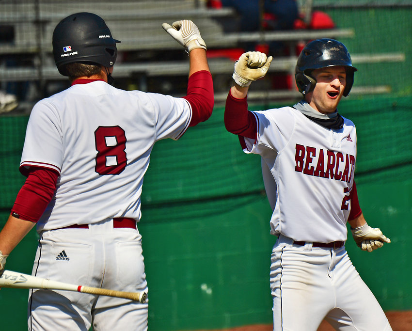W.F. West High School baseball players Brit Lusk, left, and Max Taylor celebrate after Taylor hit a double and then subsequently scored in the first inning against Shelton High School in a 2A playoff game in Chehalis on Tuesday, May 4.