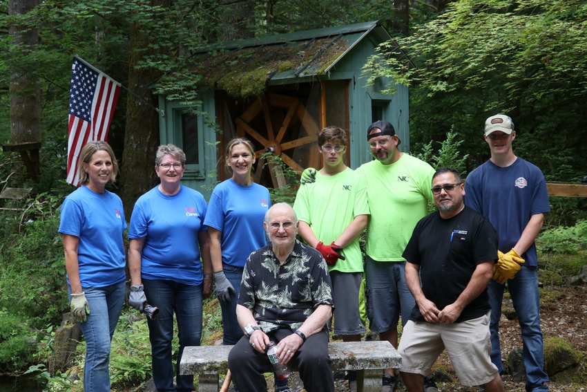 Yacolt resident and Army veteran Bob Kroupa, center, sits alongside Operation Home Rescue volunteers.