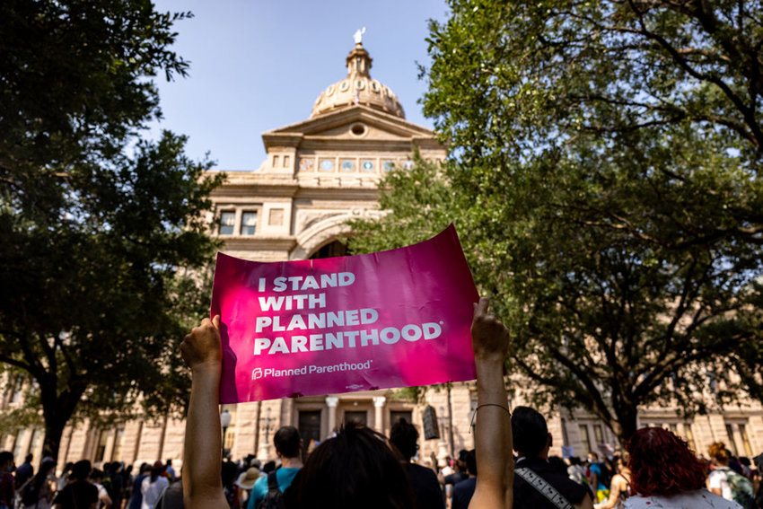 An abortion rights activist holds a sign in support of Planned Parenthood at a rally at the Texas State Capitol on Sept. 11, 2021 in Austin, Texas. (Jordan Vonderhaar/Getty Images/TNS)