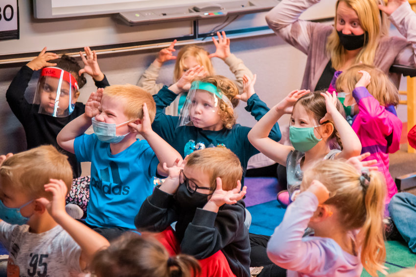 Students enrolled in the Morton Elementary School Transitional Kindergarten program hold their hands on their head like antlers during a listening exercise Thursday afternoon.
