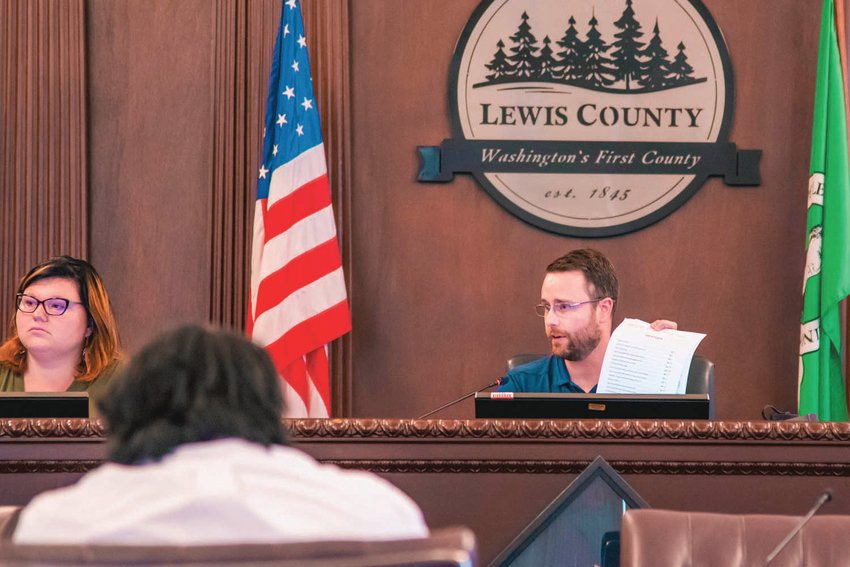 Kevin Nelson, chair of the Dangerous Animal Designation board, holds up papers during a hearing in the Lewis County Historical Courthouse in Chehalis in this file photo.