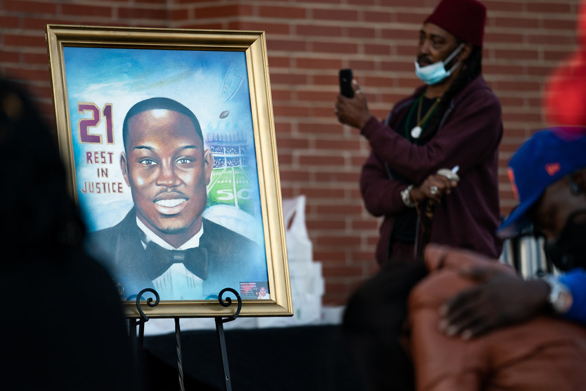 A painting of Ahmaud Arbery is displayed during a vigil at New Springfield Baptist Church on Feb. 23, 2021, in Waynesboro, Georgia. Arbery, a Black man, was shot and killed while jogging near Brunswick, Georgia a year ago after being chased by two white men. (Sean Rayford/Getty Images/TNS)