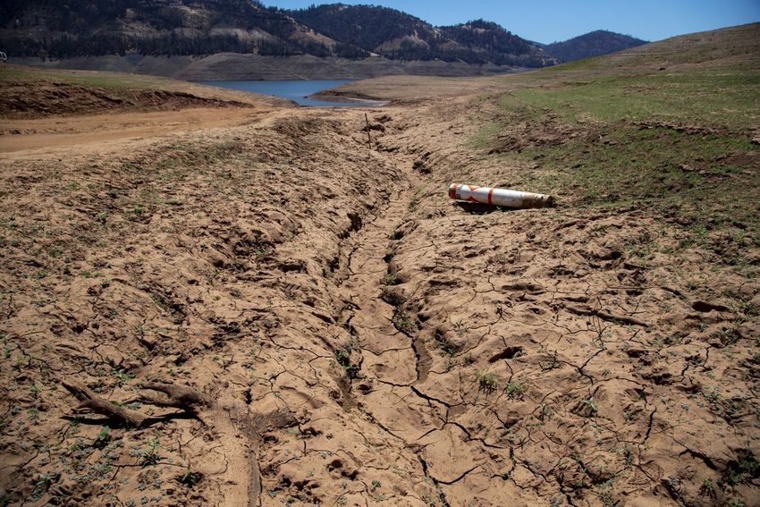 Dried mud and a stranded buoy on the lakebed at Lake Oroville, which stands at 33 percent full and 40 percent of historical average when this photograph was taken on Tuesday, June 29, 2021 in Oroville, CA. (Brian van der Brug / Los Angeles Times)