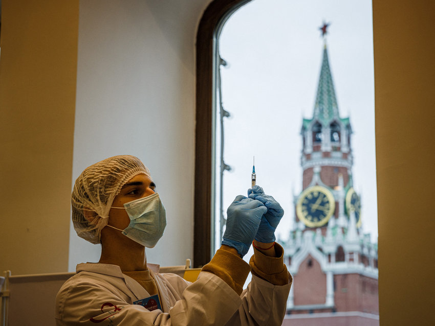 A health care worker administers a dose of Russia's Sputnik V COVID-19 vaccine to a patient at a vaccination centre in the GUM State Department store in Moscow on Thursday, Oct. 21, 2021. Moscow will shut non-essential services between Oct. 28 and Nov. 7, its mayor said Thursday, as coronavirus deaths soar and vaccination rates stall in Russia, the country in Europe hardest hit by the pandemic. (Dimitar Dilkoff/AFP/Getty Images/TNS)