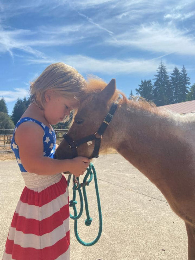Faith Tyrell is pictured with her foster horse, Lucy.