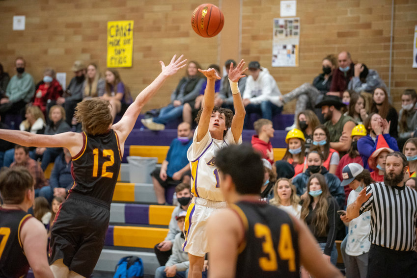 Onalaska's Mason Ulery shoots a 3-pointer while Winlock's Chase Schofield (12) defends on Dec. 9.