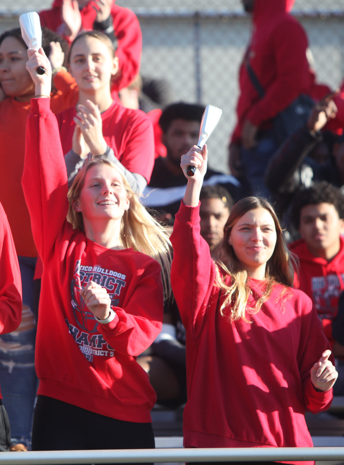 Mexico students Lily Yager and Taylor Wieberg ring their cowbells.  [Theo Tate]