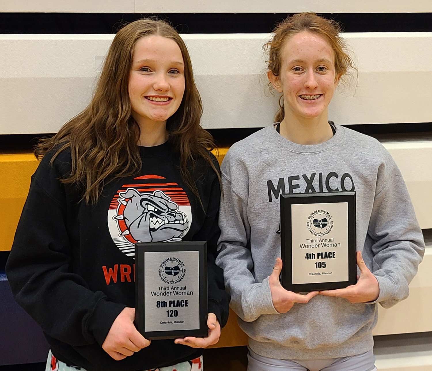Abby Drew and Katie Bowen pose with their eighth and fourth place plaques following the Wonder Woman Wrestling Tournament. [Photo courtesy of Tony Senor]