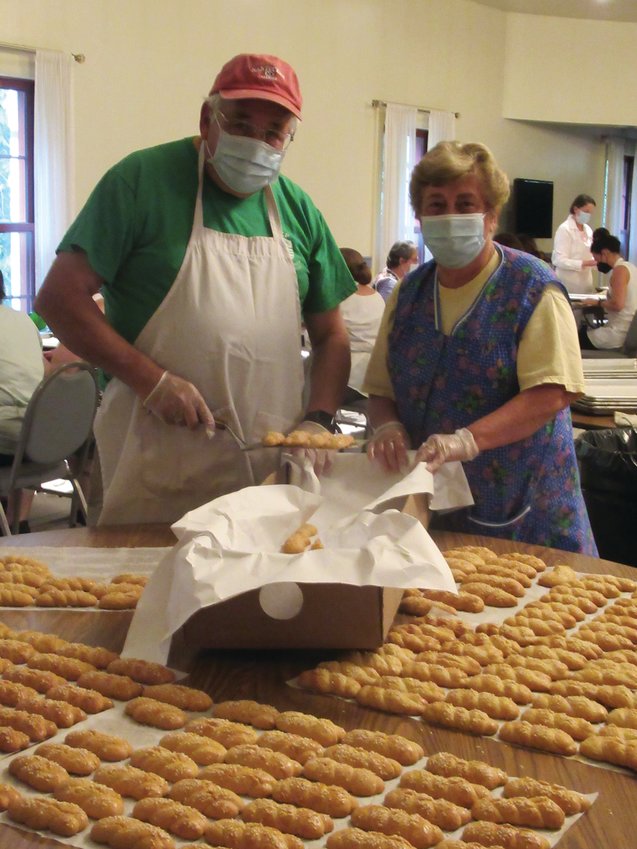 PROUD PACKERS: Cranston Greek Festival co-chairman Kevin Phelan and pastry chair Koula Rougas were busy this week packing away some of the 15,000 Koulourakia, traditional Greek coffee cookies, that will be among countless sweets this weekend.