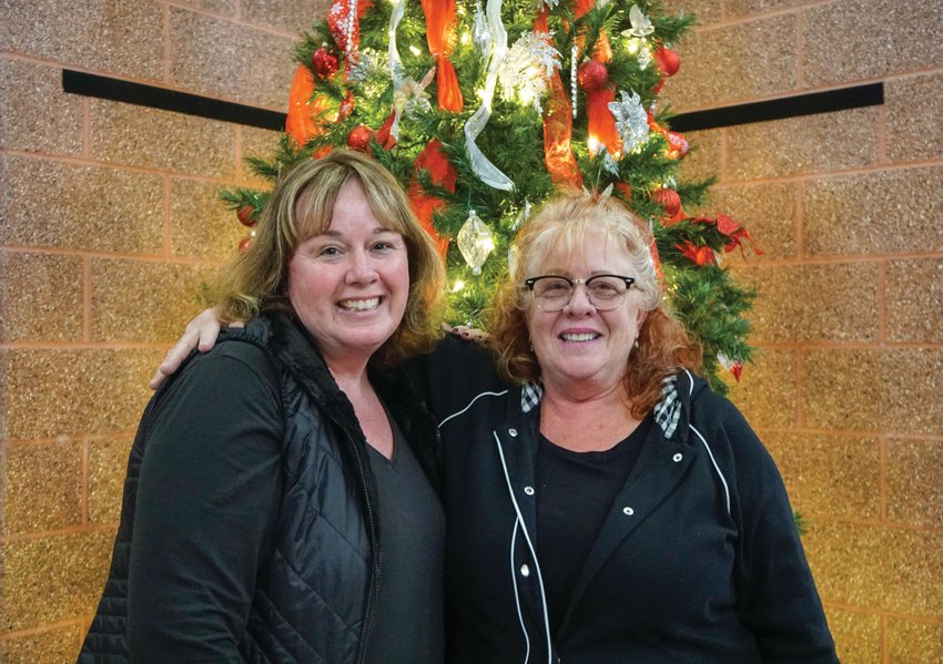 LABOR OF LOVE: Deana Barlow and Diane Williams pose with this year's Giving Tree, a program which they both coin a 'labor of love'. The pair have been working together to brighten West family holidays for the past 25 years, and have stated neither has plans to stop this all-important holiday work.&nbsp;